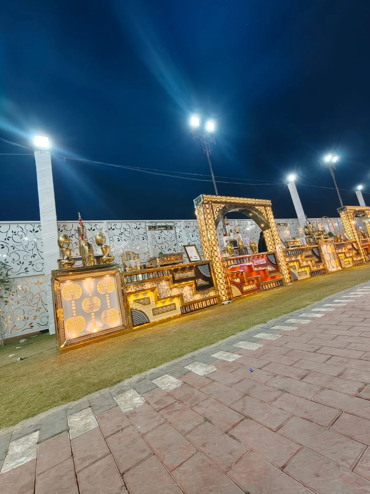 Grand illuminated vegetarian catering counters along an event walkway