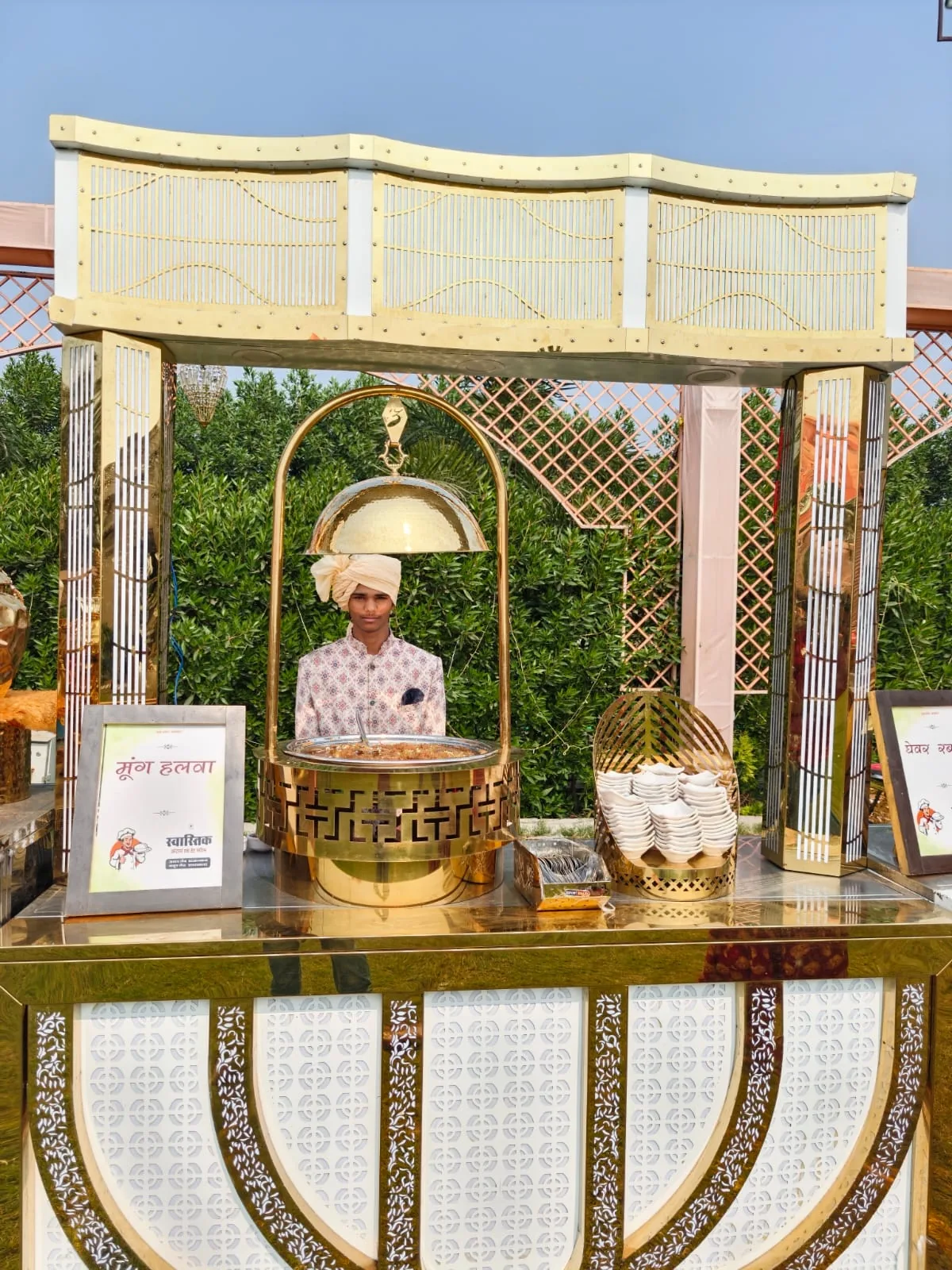 Traditional moong halwa live station with uniformed server