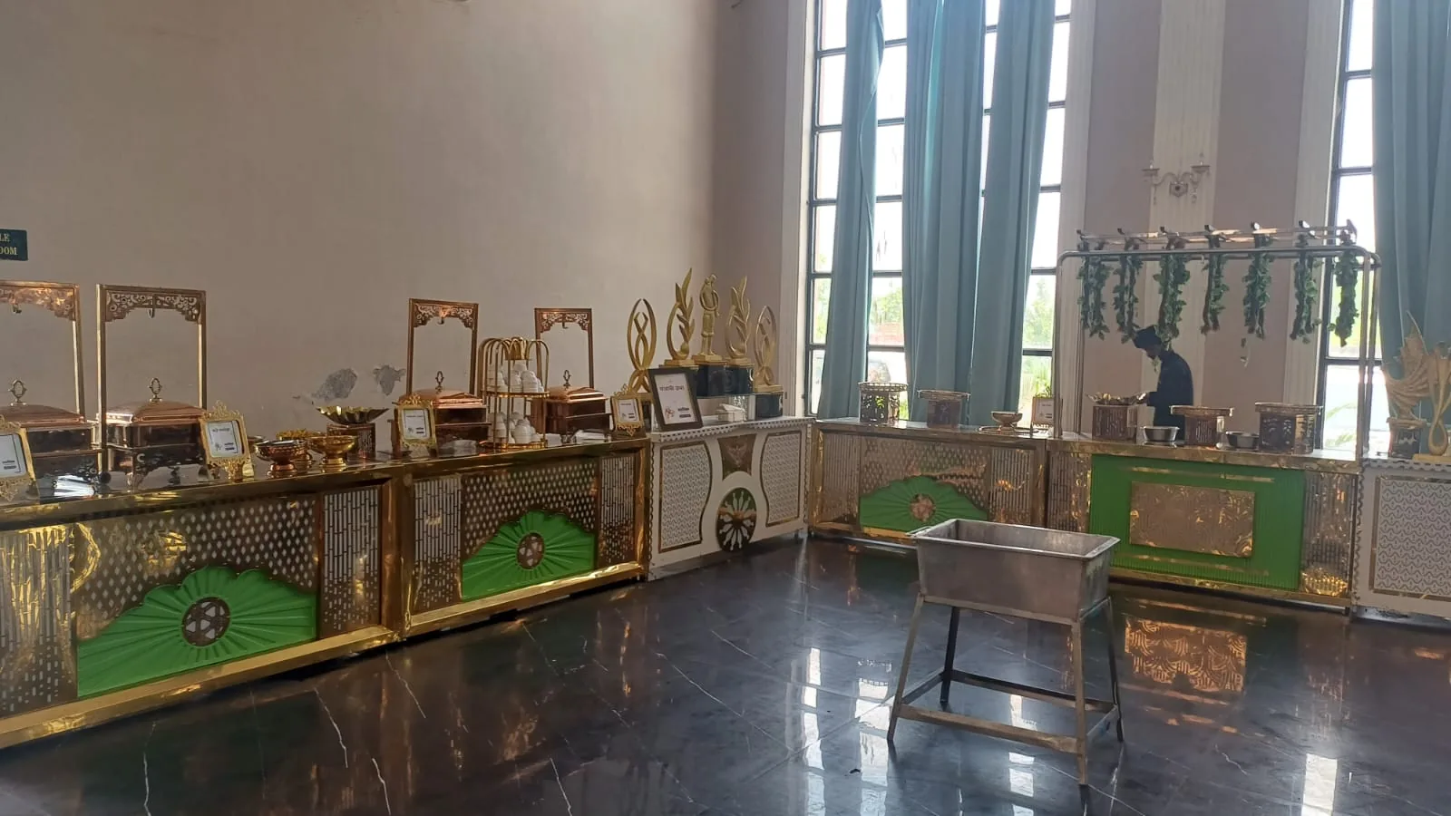 Indoor gold and green wedding buffet setup