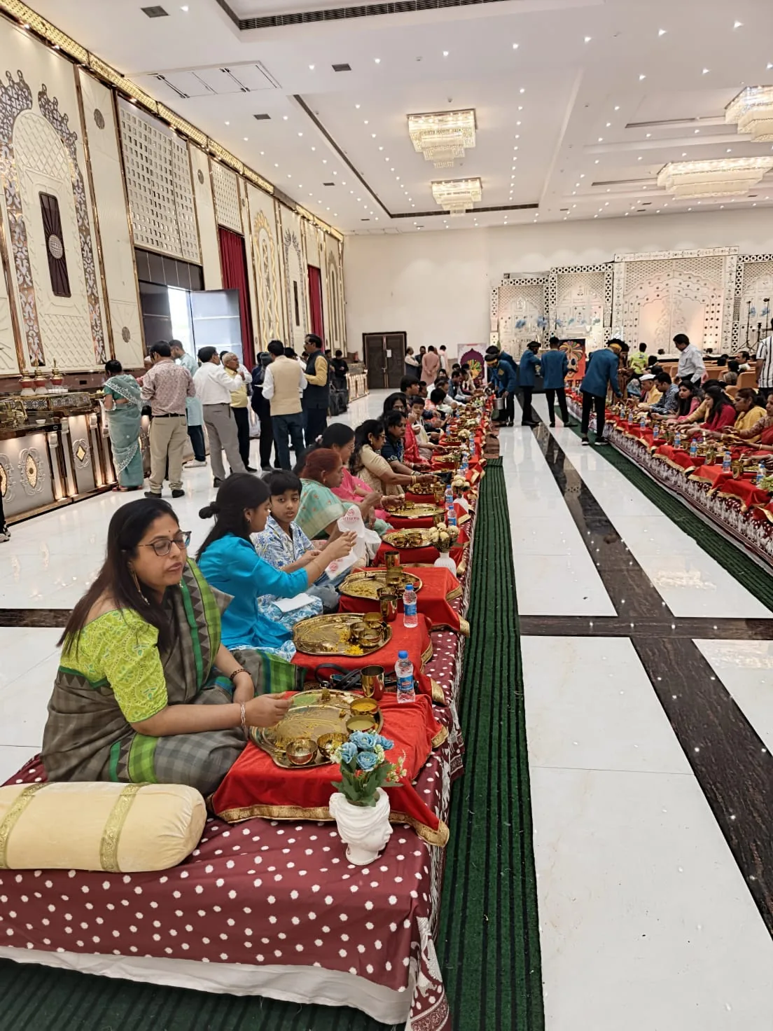 Large traditional seated dining arrangement inside a banquet hall